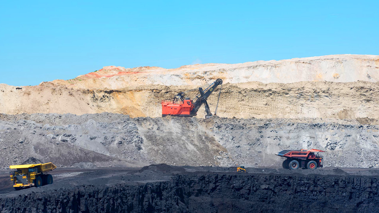 Exploring the vast Eagle Butte Coal Mine, a top thing to do for industrial tourism in Wyoming, showcasing large mining equipment against stark terrain