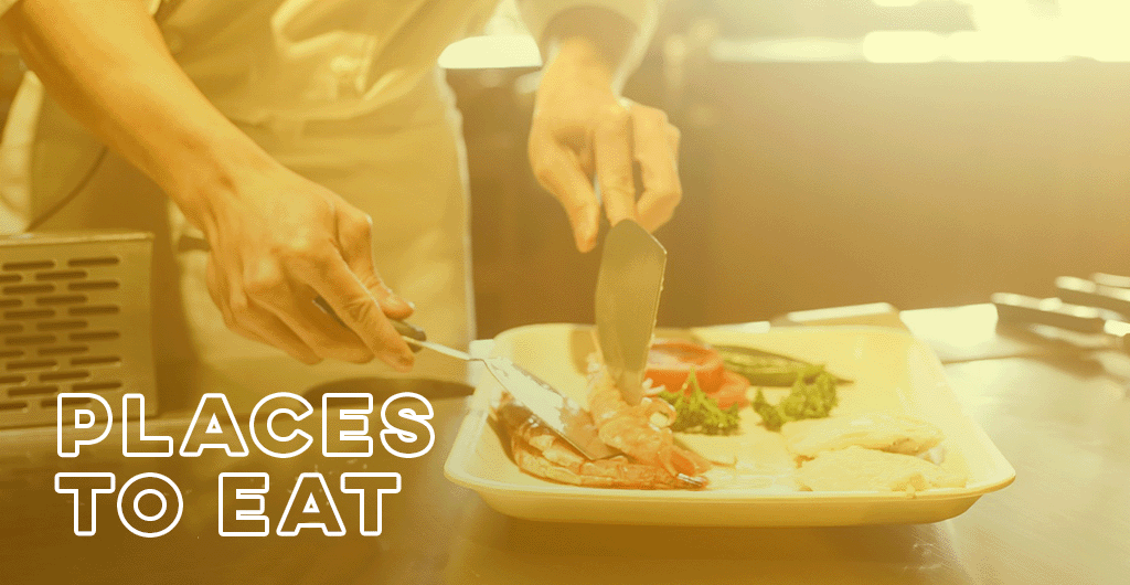The words, "Places to Eat" layered over an image of a chef plating a meal in restaurant kitchen.