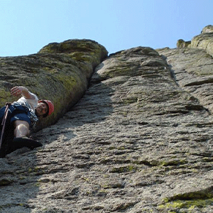A person climbing the El Cracko Diablo Route at Devils Tower National Monument.