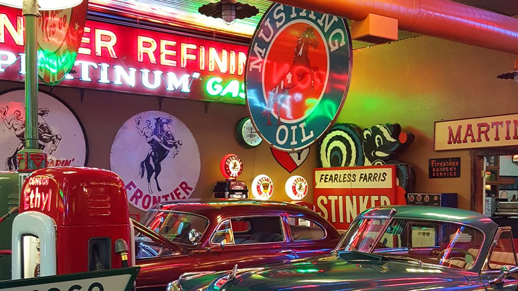 Inside Frontier Auto Museum, vintage cars shine under neon lights, a top thing to do for automotive history buffs in Gillette, Wyoming.
