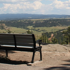 A close up view of a bench on the Tower Trail overlooking the surrounding landscape.