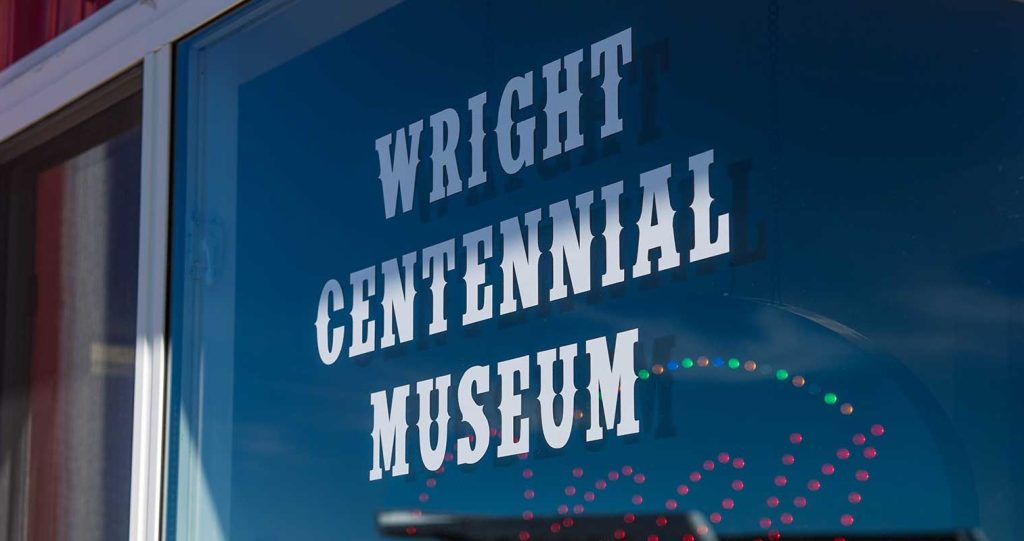The blue and white sign of the Wright Centennial Museum beckons history lovers, a top thing to do for exploring local heritage in Wyoming.