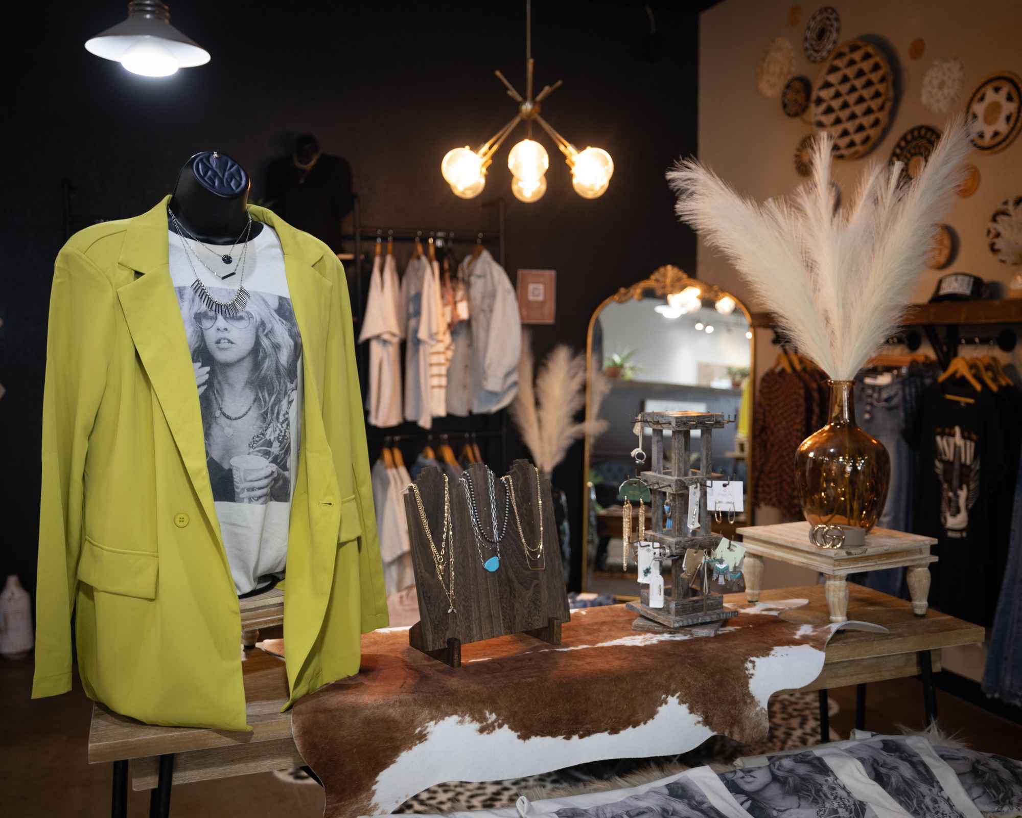 Clothing displayed on racks and tables inside The Clothesline Boutique.