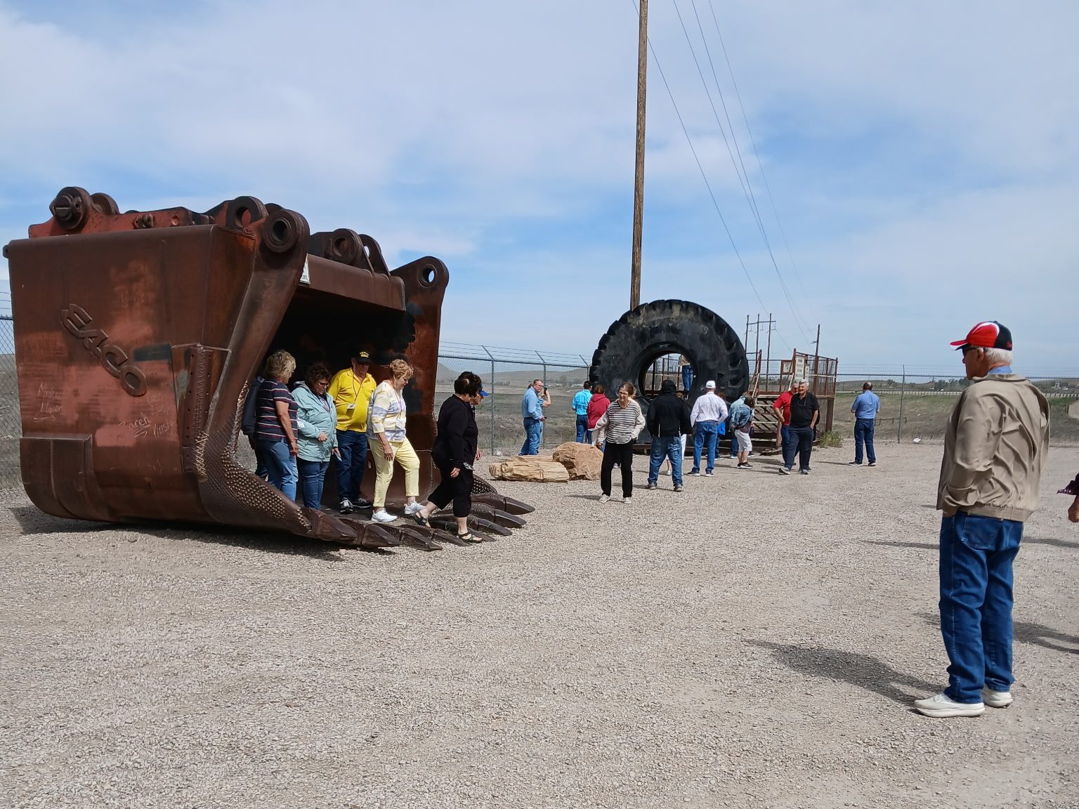 Tour visitors standing inside the massive bucket of a coal mine excavator at Eagle Butte Mine